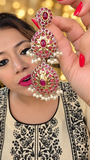 Ruby-pink dual-tone statement earrings with tiered motifs and pearl-style fringe