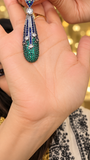 Elongated drop earring with blue sparkling stones graduating to green