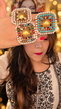 Turquoise, white and multicolor statement rings shown together; turquoise is the right-hand ring