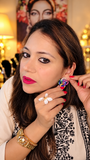 Oversized multicolor Victorian-finish stud earring worn on the ear