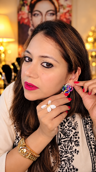 Oversized multicolor Victorian-finish stud earring worn on the ear
