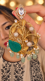 Statement earring with an engraved jade leaf, ornate gold-tone wirework and pale-green drops